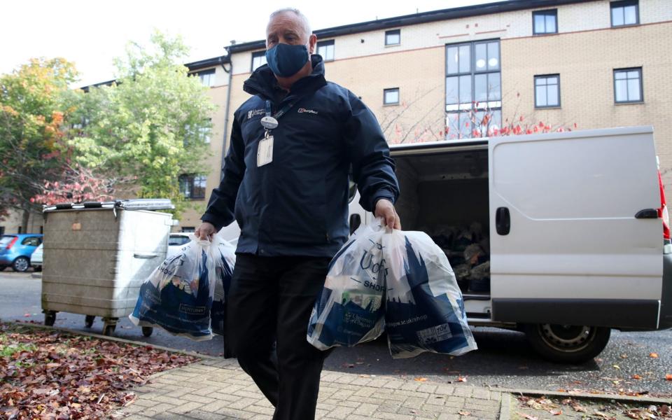 Food parcels are handed out by the University of Glasgow to students staying at the Murano Street Student Village. - Andrew Milligan/PA