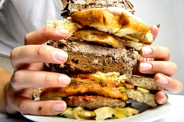 Studio shot of a hands holding a burger