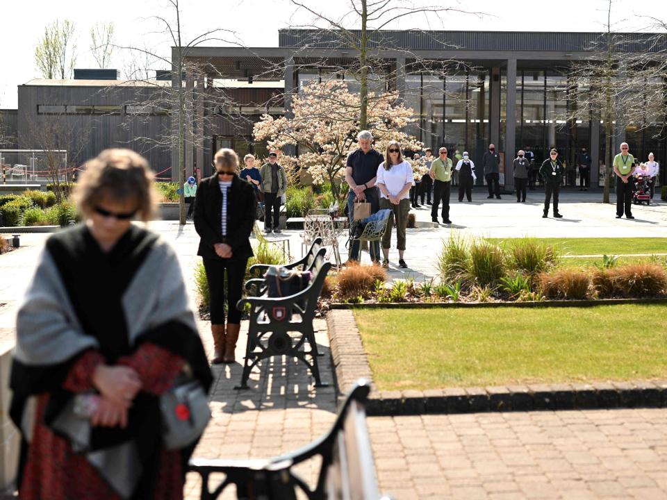 Members of the public observe a minute's silence at The National Memorial Arboretum at Alrewas in central EnglandAFP via Getty Images