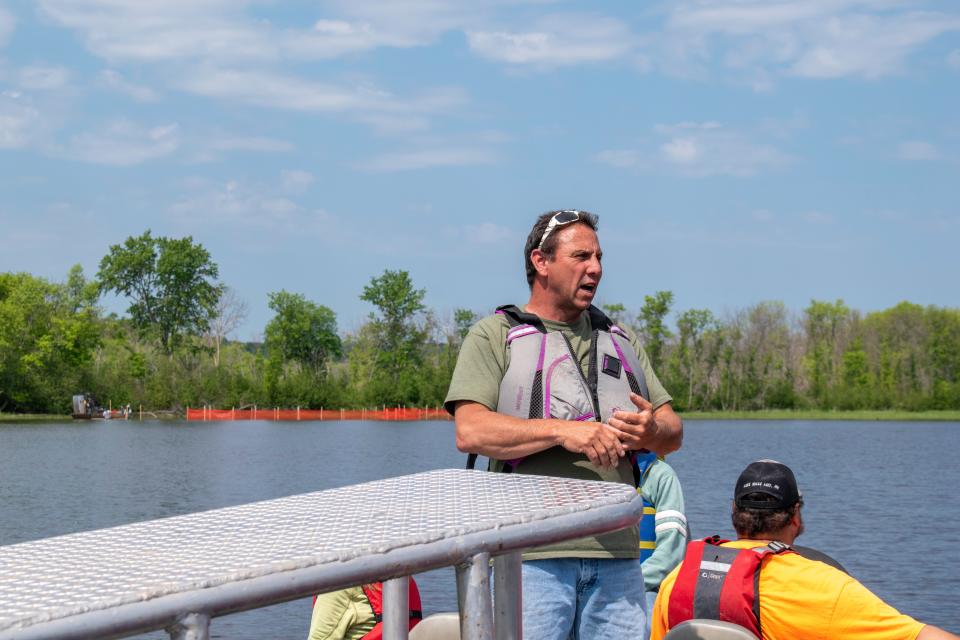 Terry Perrault, the lead technician for the Fond du Lac Band’s Natural Resources Department, in the St. Louis River on June 12. He stands in front of a bed of wild rice in exclosures to help protect it from Canadian geese.