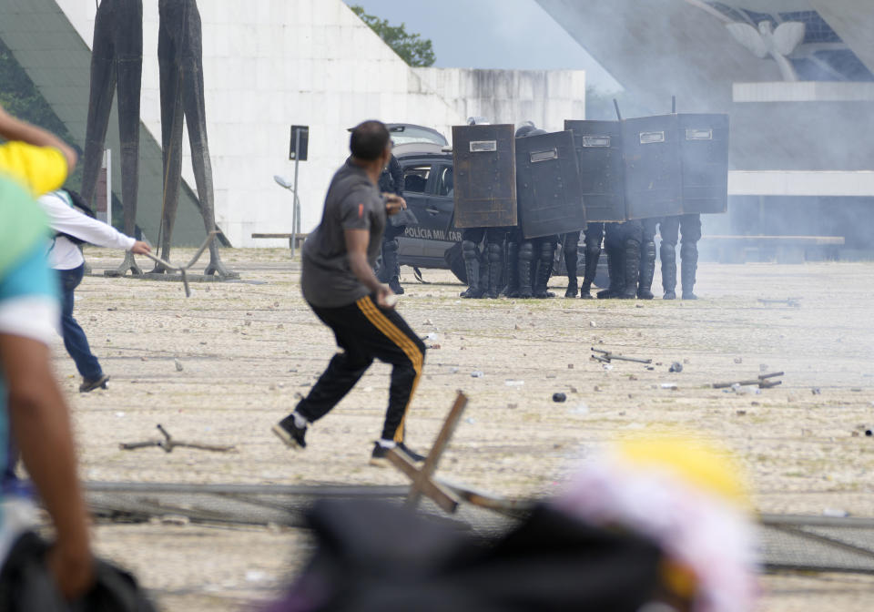 Supporters of Brazil's former president Jair Bolsonaro clash with police as they storms the Planalto Palace in Brasilia, Brazil, Sunday, Jan. 8, 2023. Planalto is the official workplace of the president of Brazil. (AP Photo/Eraldo Peres)