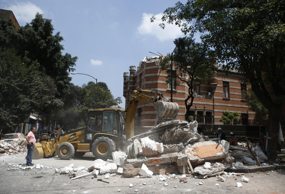 <p>A bulldozer removes debris from a partially collapsed building after an earthquake in Mexico City, Tuesday, Sept. 19, 2017. A powerful earthquake jolted central Mexico on Tuesday, causing buildings to sway sickeningly in the capital on the anniversary of a 1985 quake that did major damage. (AP Photo/Rebecca Blackwell) </p>