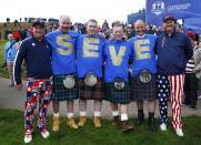 Spectators pose wearing tee shirts with the name "Seve" in memory to Seve Ballesteros, during practice ahead of the 2014 Ryder Cup at Gleneagles in Scotland September 25, 2014. REUTERS/Eddie Keogh (BRITAIN - Tags: SPORT GOLF)