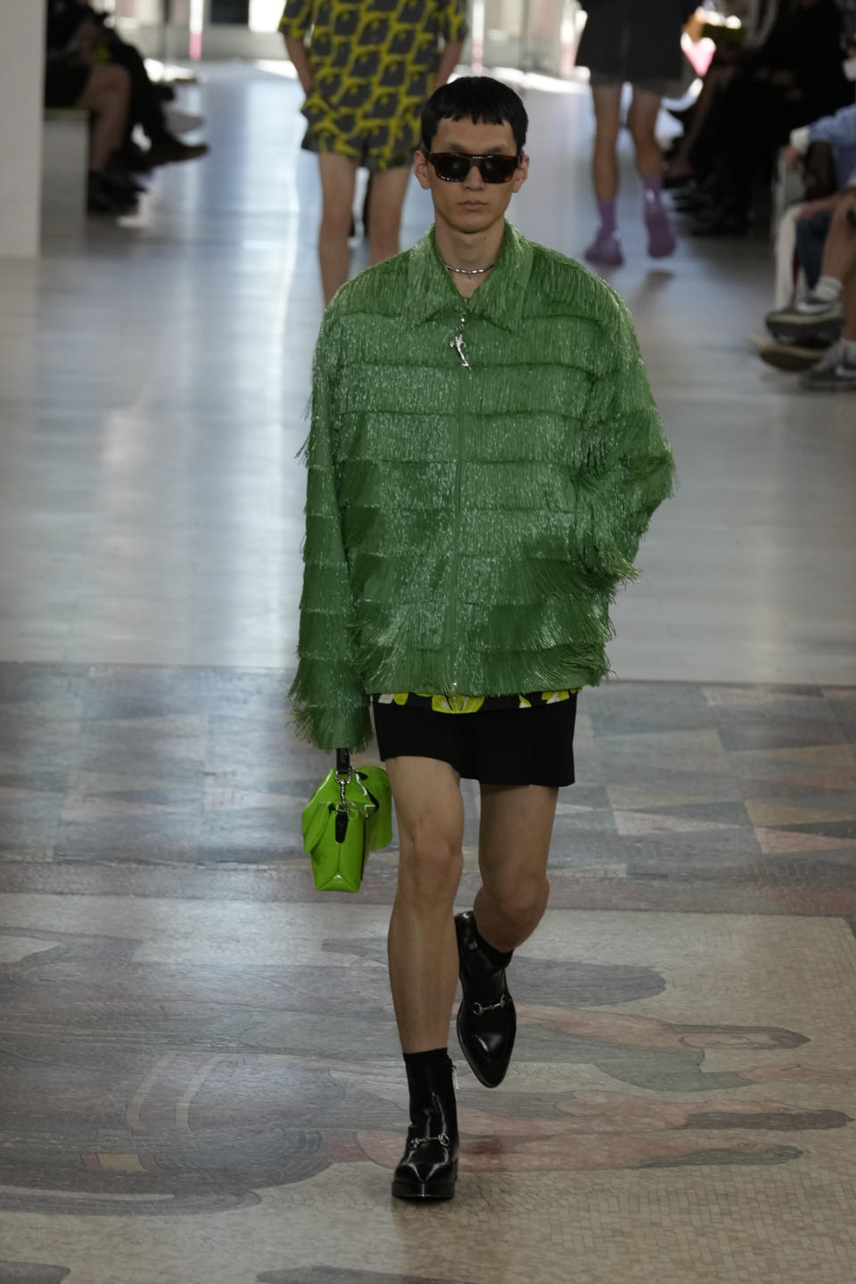 A model wears a creation as part of the Gucci men's Spring Summer 2025 collection, that was presented in Milan, Italy, Monday, June 17, 2024. (AP Photo/Luca Bruno)