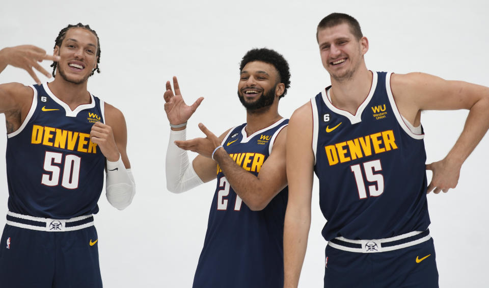 From left to right, Denver Nuggets forward Aaron Gordon, guard Jamal Murray and center Nikola Jokic joke around while having their photographs taken during the NBA basketball team's Media Day, Monday, Sept. 26, 2022, in Denver. (AP Photo/David Zalubowski)