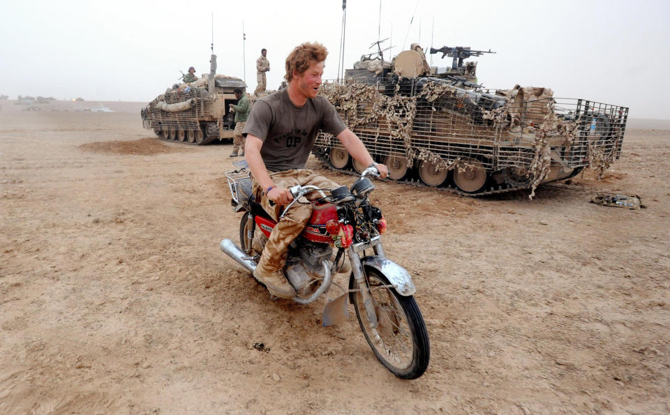 HELMAND PROVINCE- FEBRUARY 21: (NO PUBLICATION IN UK MEDIA FOR 28 DAYS)  Prince Harry tries to start an abandoned motorcycle in the desert on February 21, 2008 in Helmand Province, Afghanistan.  (Photo by John Stillwell - POOL/Anwar Hussein Collection/WireImage)