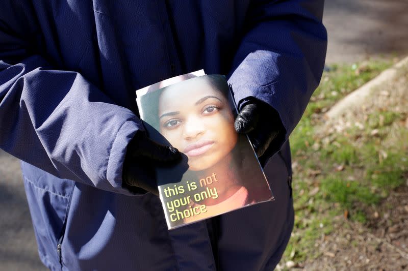 A protester offers pamphlets to patients entering the Hope Medical Group for Women in Shreveport