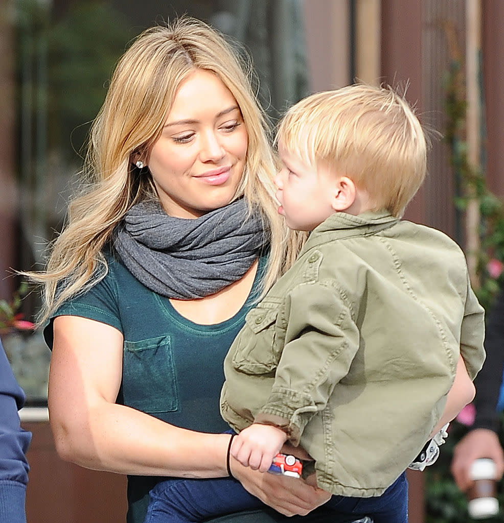 Hillary Duff holds her child