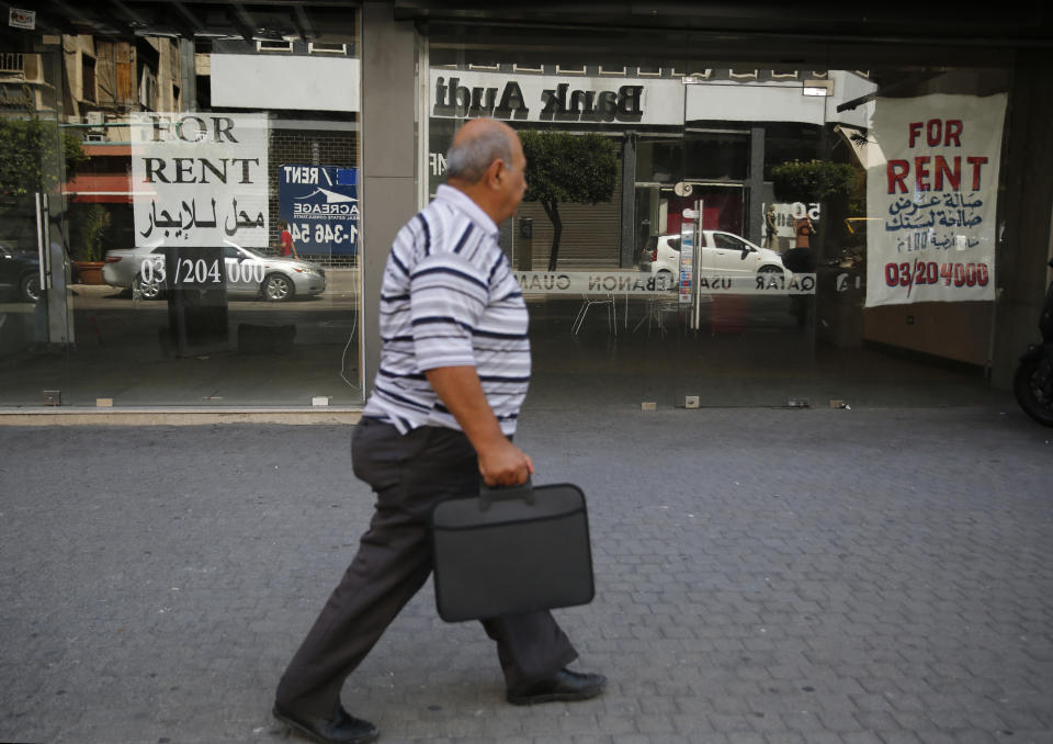 In this Thursday, July 18, 2019 photo, closed shops are offered for rent, in Beirut, Lebanon. As the economic crisis deepens in Lebanon, so has the public’s distrust in the ability of the old political class, widely viewed as corrupt and steeped in personal rivalries, to tackle major reform. Many fear a Greek-style bankruptcy, without the European Union to fall back on, and with a potentially more violent social unrest in the small country wedged between war-torn Syria and Israel. (AP Photo/Hussein Malla)