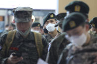 Military soldiers wearing face masks line up to buy train tickets as they are allowed to go on leave after more than two months of restrictions during heightened concerns of the coronavirus pandemic at the Seoul Railway Station in Seoul, South Korea, Friday, May 8, 2020. South Korean officials sounded alarms Friday after finding more than a dozen coronavirus infections linked to club goers in the densely populated Seoul metropolitan area. (AP Photo/Ahn Young-joon)