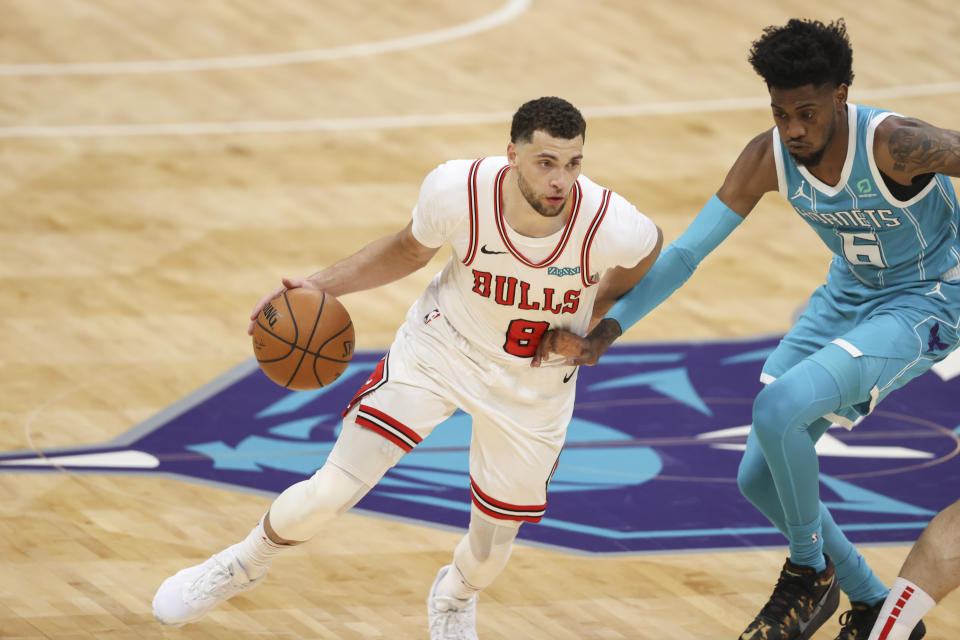 Chicago Bulls guard Zach LaVine, left, drives against Charlotte Hornets forward Jalen McDaniels during the second half of an NBA basketball game in Charlotte, N.C., Thursday, May 6, 2021. (AP Photo/Nell Redmond)