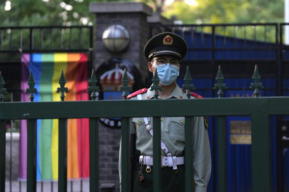 A Chinese paramilitary policemen stands guard outside the Swedish embassy during the opening ceremony for Diversity Week in Beijing, Friday, May 12, 2023. On Monday, May 15, 2023, the advocacy group the Beijing LGBT Center became the latest organization to close under a crackdown by Chinese leader Xi Jinping's government. (AP Photo/Ng Han Guan)