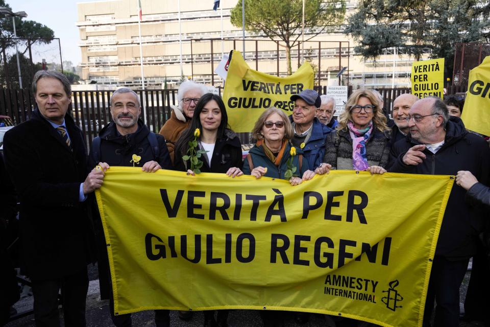 Paola, mother of Giulio Regeni, is flanked by by her husband Claudio as the hold a banner reading in Italian 'Truth for Giulio Regeni' prior to the start of the trial for the killing of Cambridge University researcher Giulio Regeni, at the Rome's court, Tuesday, Feb. 20, 2024. Four high-level Egyptian security officials are going on trial in absentia in a Rome court, accused in the 2016 abduction, torture and slaying of an Italian doctoral student in Cairo. (AP Photo/Andrew Medichini)
