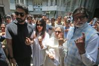 Bollywood star Amitabh Bachchan, son Abhishek Bachchan, Aishwarya Rai Bachchan and Jaya Bachchan show ink marks on their fingers after casting their votes at a polling station in Mumbai