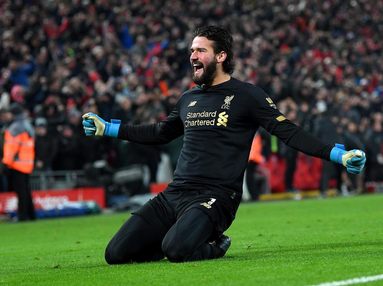 Alisson celebrates his assist against Manchester United: Getty