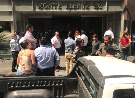 People stand outside a building after an earthquake in Mexico City, Mexico April 22, 2019. REUTERS/Carlos Jasso