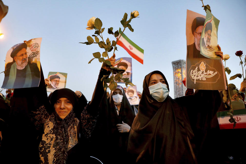 Supporters of Iranian president-elect Ebrahim Raisi celebrate after he won the presidential election in Tehran, Iran, Saturday, June 19, 2021. Initial results released Saturday propelled Raisi, a protege of the country's supreme leader, into Tehran’s highest civilian position. The vote appeared to see the lowest turnout in the Islamic Republic’s history. (AP Photo/Ebrahim Noroozi)