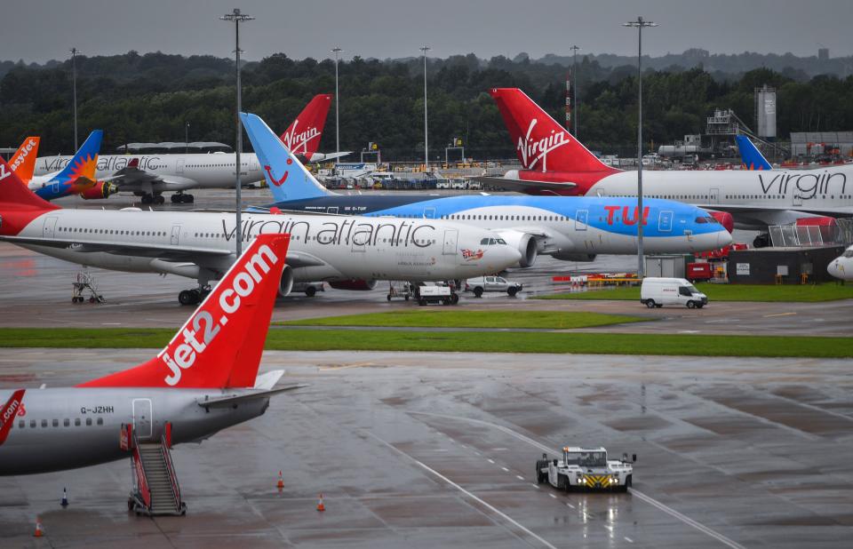 Aircraft operated by TUI, Virgin Atlantic, Easyjet and Jet2, are pictured at Manchester Airport in Manchester, north west England on July 27, 2020, following the holiday operator TUI's decision to cancel all holidays to mainland Spain, due to a spike in the number of COVID-19 cases there. - Tour operator TUI has cancelled all British holidays to mainland Spain from Monday until August 9, after the UK government's decision to require travellers returning from the country to quarantine. The newly-imposed rule to self-isolate, abruptly introduced at midnight Saturday hours after being announced, follows a surge in novel coronavirus cases in parts of Spain in recent weeks. (Photo by Anthony Devlin / AFP) (Photo by ANTHONY DEVLIN/AFP via Getty Images)