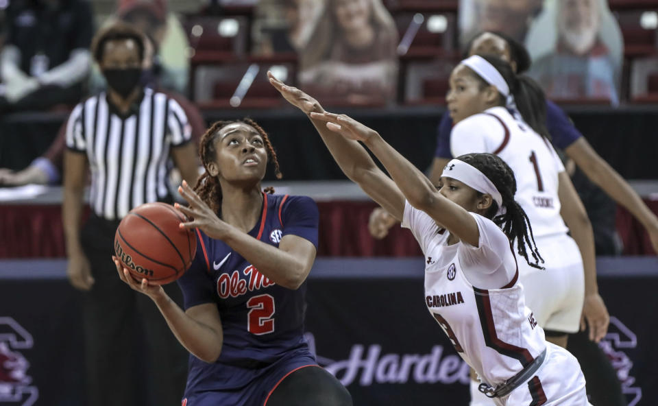 Mississippi guard Mimi Reid (2) shoots as South Carolina guard Destanni Henderson (3) defends during an NCAA college basketball game in Columbia, S.C., Thursday, Feb. 25, 2021. (Tracy Glantz/The State via AP)