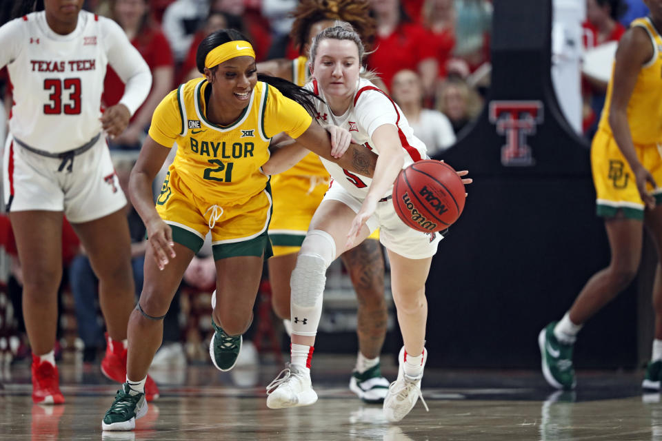 Baylor's Ja'Mee Asberry (21) steals the ball from Texas Tech's Rhyle McKinney (5) during the first half of an NCAA college basketball game on Wednesday, Jan. 26, 2022, in Lubbock, Texas. (AP Photo/Brad Tollefson)