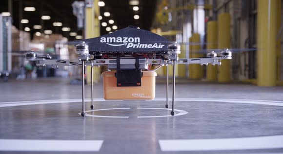 A package-delivery drone marked "Amazon PrimeAir", on a landing pad.