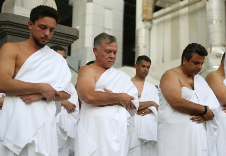 Jordan's King Abdullah II (C) and his son Crown Prince Hussein bin Abdullah (L) perform the off-season pilgrimage of Umra in the holy city of Mecca in June 2018