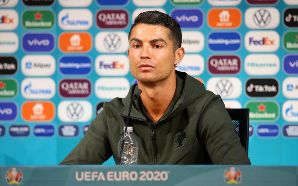 Cristiano Ronaldo moving two bottles of Coca-Cola out of his way at a press conference on Tuesday - Football's reliance on junk-food sponsorship - and why Cristiano Ronaldo could be a figurehead for change - SHUTTERSTOCK