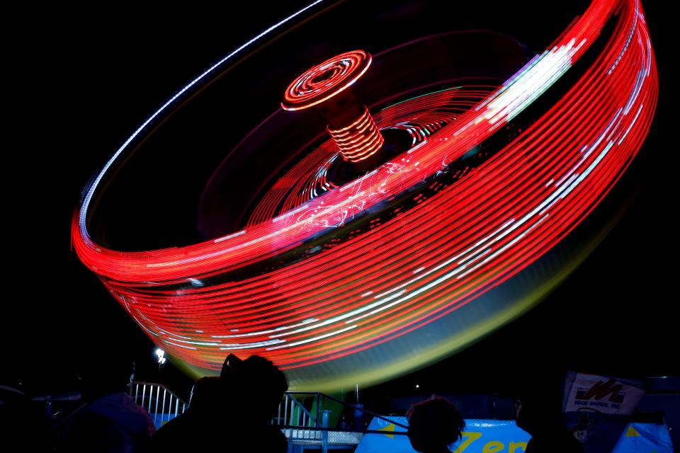 People watch a ride while waiting in line at the 2023 Oklahoma State Fair in Oklahoma City