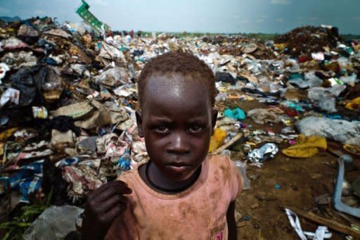 A young child scavanges for food at a rubbish dump in the South Sudanese capital Juba on August 1. The increase of prices in South Sudan makes life very difficult for South Sudanese people, some of them have no other choice but to pick up food or find and sell iron from rubbish dumps