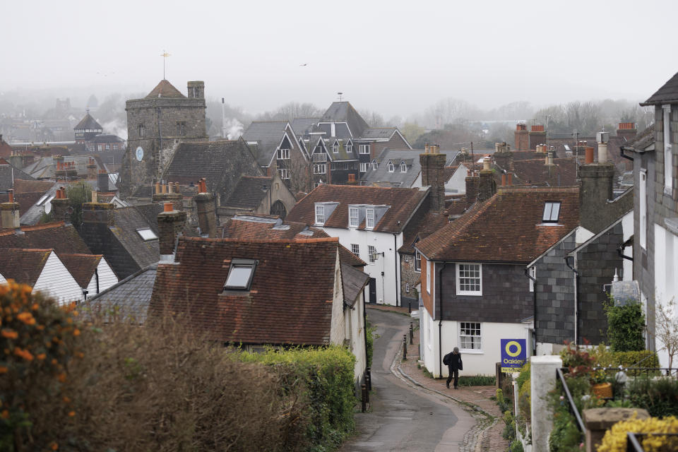 houses LEWES, ENGLAND - MARCH 21: A member of the public walks up a steep residential street on March 21, 2024 in Lewes, England. Research by The Countryside Charity (CPRE) has revealed that median incomes are often insufficient to cover over half of the rent for an average two-bedroom property. Sevenoaks, Bath, and northeast Somerset, Tandridge, Chichester, and Lewes have been highlighted as the least affordable rural areas in the UK. (Photo by Dan Kitwood/Getty Images)