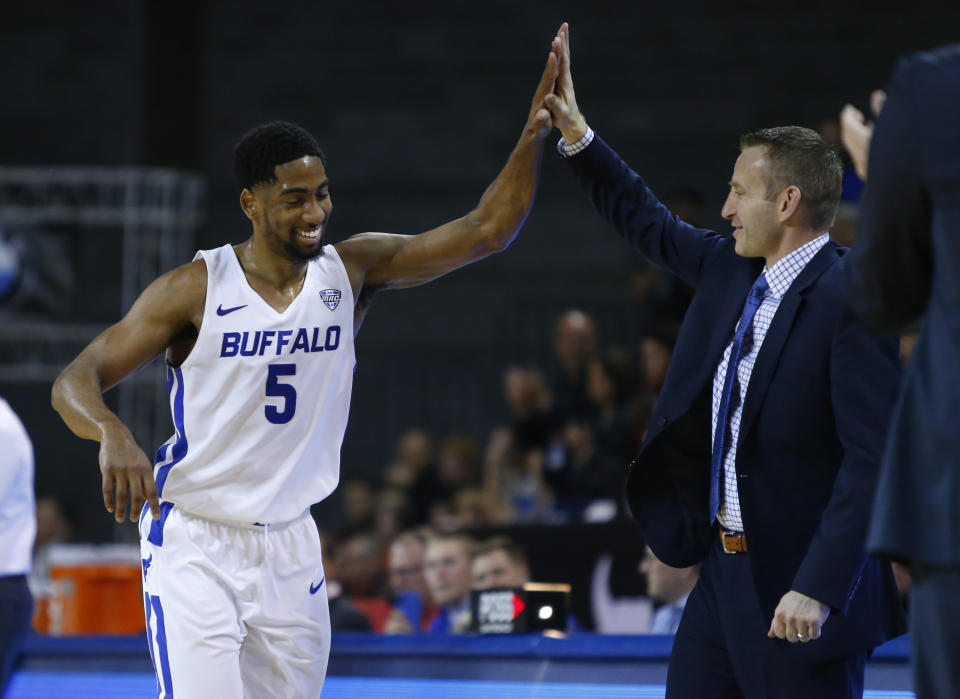 Buffalo guard CJ Massinburg (5) and head coach Nate Oats high five during the second half of an NCAA college Basketball game against Bowling Green, Friday, March 8, 2019, in Buffalo N.Y. (AP Photo/Jeffrey T. Barnes)