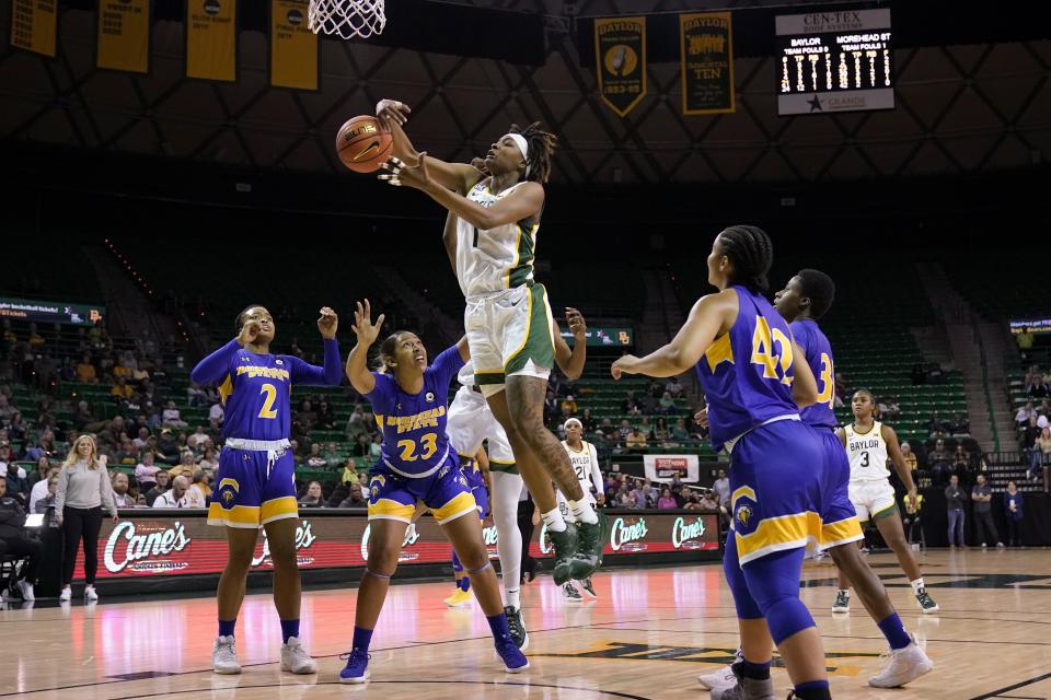 Baylor forward NaLyssa Smith (1) goes up to collect a rebound between Morehead State's Jada Claude (2), Aiden Rainford (23) and Tyler Moore (42) during the second half of an NCAA college basketball game in Waco, Texas, Tuesday, Nov. 30, 2021. (AP Photo/Tony Gutierrez)