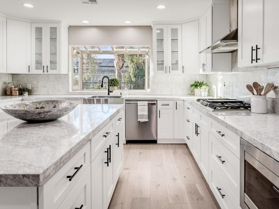 A kitchen with an island and large countertops.
