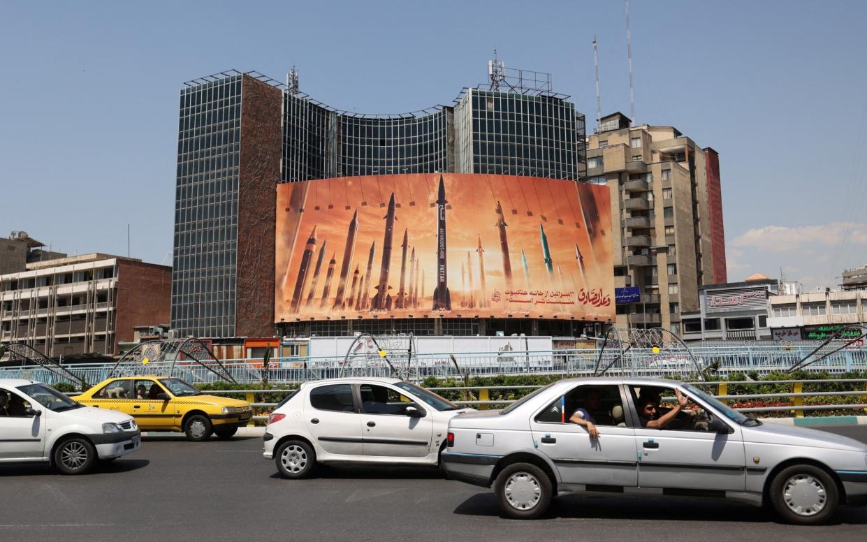 An anti-Israel billboard with a picture of Iranian missiles is seen on a street in Tehran