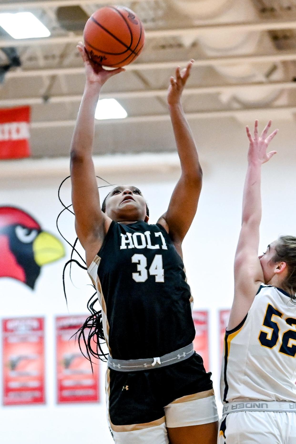 Holt's Janae Tyler scores against DeWitt during the third quarter on Thursday, March 9, 2023, at Coldwater High School.