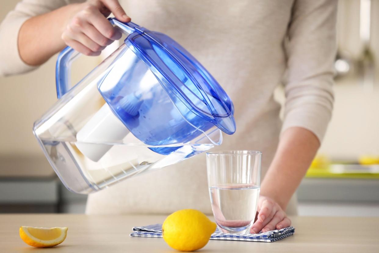 pouring filtered water into glass