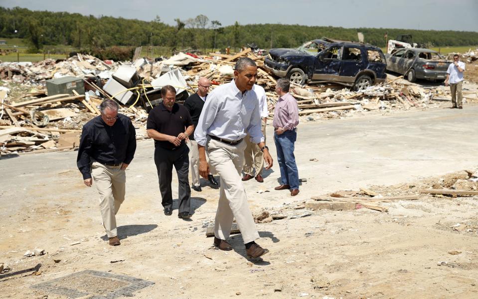 U.S. President Barack Obama visits the tornado devastated town of Vilonia, Arkansas May 7, 2014. The tornadoes were part of a storm system that blew through the Southern and Midwestern United States earlier this week, killing at least 35 people, including 15 in Arkansas. Obama has already declared a major disaster in Arkansas and ordered federal aid to supplement state and local recovery efforts. (REUTERS/Kevin Lamarque)