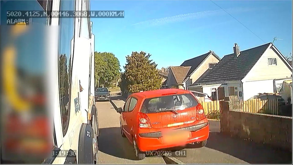 A reckless motorist mounts the curb. (SWNS)