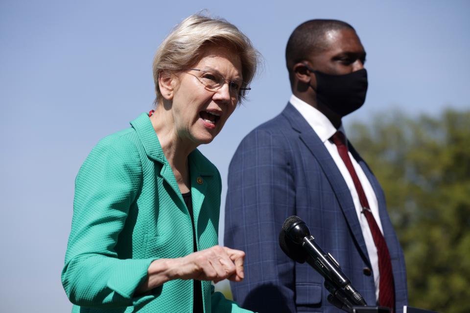 Sen. Elizabeth Warren, D-Mass., speaks as Rep. Mondaire Jones, D-N.Y., listens during a news conference outside the U.S. Capitol on April 27, 2021.