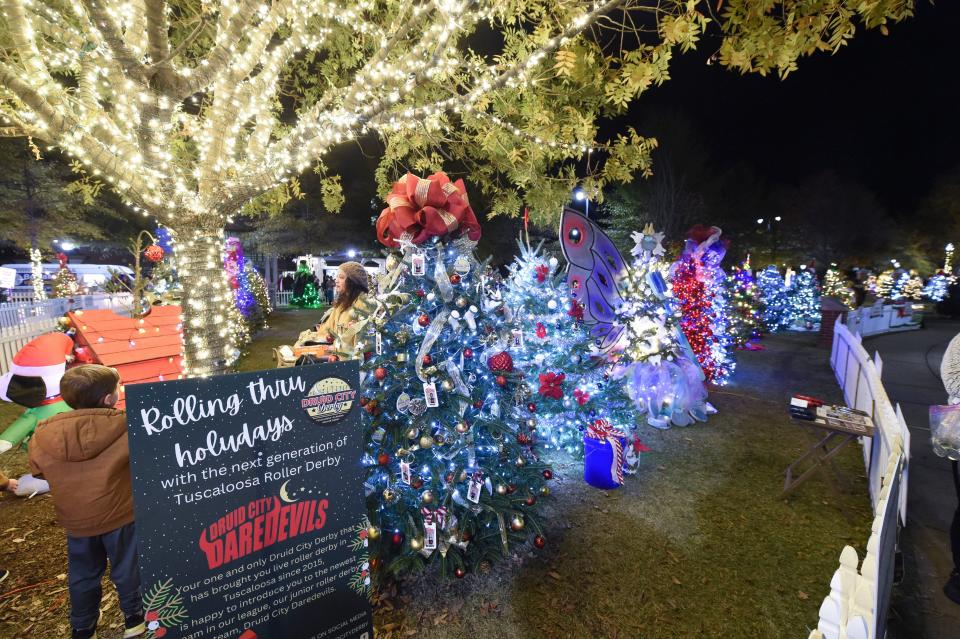 Nov 21, 2022; Tuscaloosa, Alabama, USA;  The Tinsel Trail opened in Government Plaza Monday night. Crowds of viewers walked the paths to view the decorated trees.
