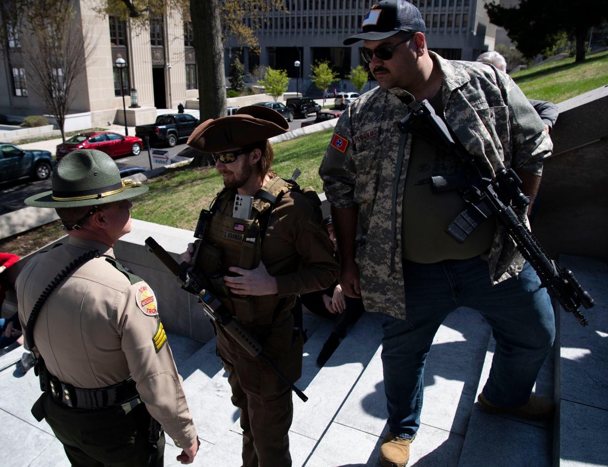 A state trooper questions, Shaun Kranish and Josiah Maldonado, of Keep and Bare.org, during a protect Tennessee’s Borders rally at Tennessee state Capitol in Nashville, Tenn., Wednesday, March 20, 2024.