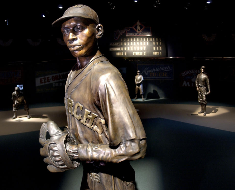 FILE - Bronze statues of Negro League greats including pitcher Satchel Paige, front, play their positions on the Field of Legends, which is the centerpiece of the Negro Leagues Baseball Museum in Kansas City, Mo., Jan. 27, 2005. The Negro Leagues Baseball Museum is embarking on a fundraising campaign to raise $25 million for a new building in Kansas City, Missouri, to house its education center and what has become one of the world's unique collections of baseball memorabilia. (AP Photo/Charlie Riedel, File)