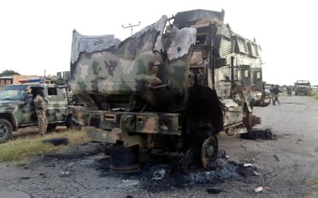FILE PHOTO: A damaged military vehicle is pictured in the northeast town of Gudumbali, after an attack by members of Islamic State in West Africa