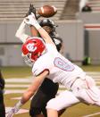 Charlotte Catholic tight end Jack Larsen (85) breaks up an interception attempt by Havelock’s Kamron Hoover (1) at the end of the first half of the NCHSAA 3A State Championship football game between Charlotte Catholic and Havelock in Raleigh on Friday, May 7, 2021.