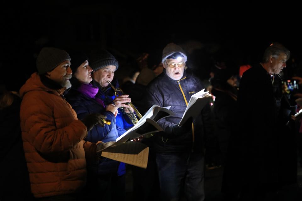 From left, Steve Miller, Amy Downes, Sarah Miller, Charles Carroll and David McNary sing Christmas carols in Staatsburg on December 14, 2022.