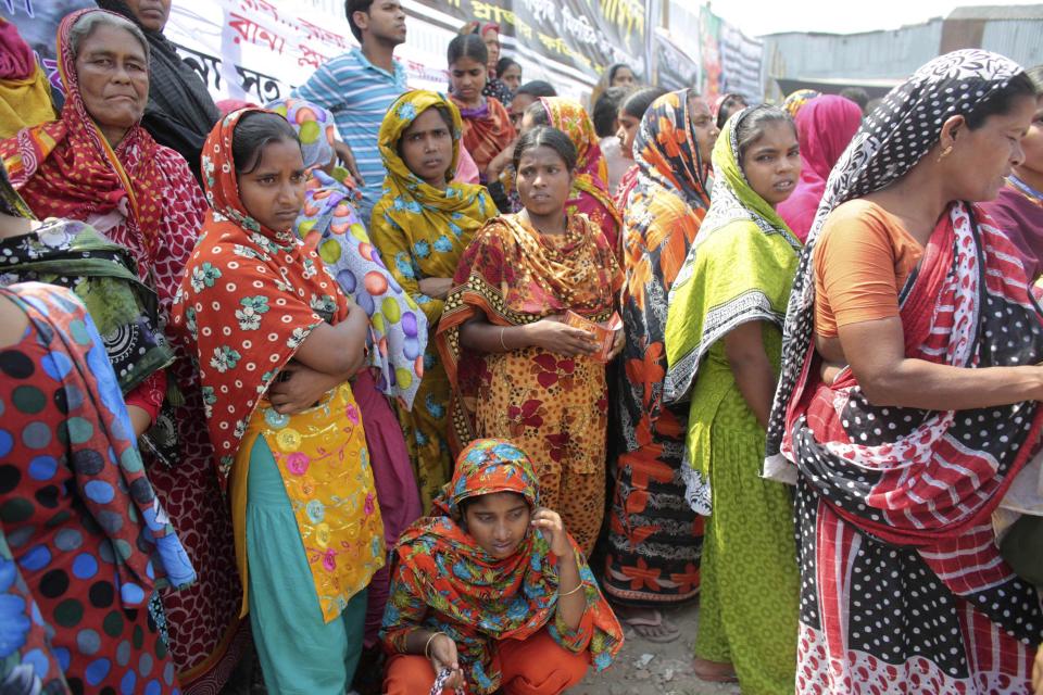 Relatives of victims who were killed or went missing in the collapse of Rana Plaza gather at the site on the first year anniversary of the accident in Savar