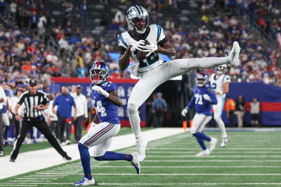 Aug 18, 2023; East Rutherford, New Jersey, USA; Carolina Panthers wide receiver Shi Smith (12) catches the ball in front of New York Giants linebacker Dyontae Johnson (54) during the second half at MetLife Stadium. Mandatory Credit: Vincent Carchietta-USA TODAY Sports Vincent Carchietta/Vincent Carchietta-USA TODAY Sports