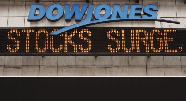 The Dow Jones ticker in Times Square displays news about the