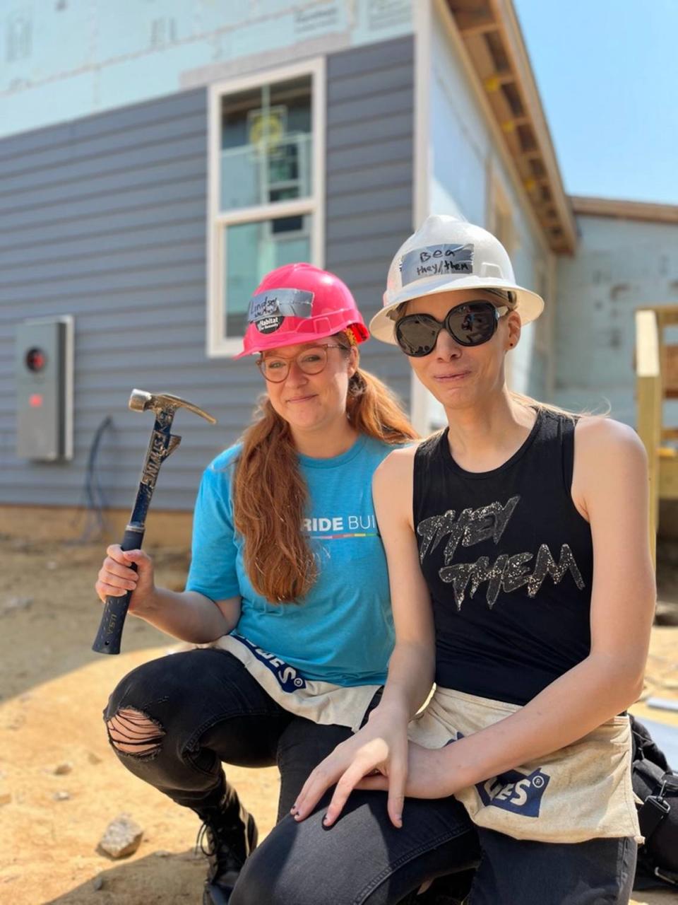 Lindsey Halliday (left) and her partner Bea helped volunteers build their first home for this year’s Pride build in Raleigh.