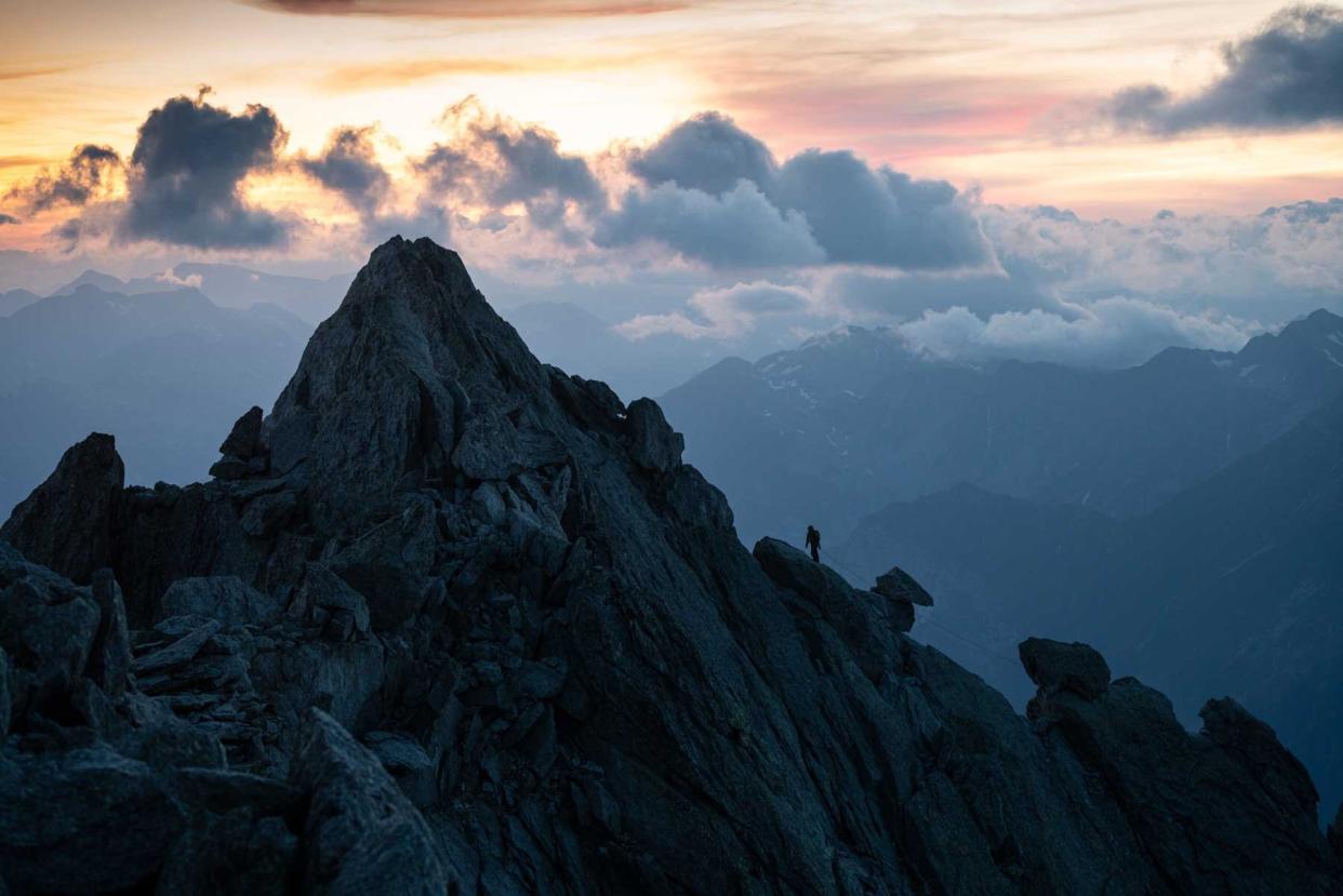 Climber ascending Piz Badile from the ridge of Piz Badilet/punta Sant'Anna, Val Masino, Sondrio province, Italy.